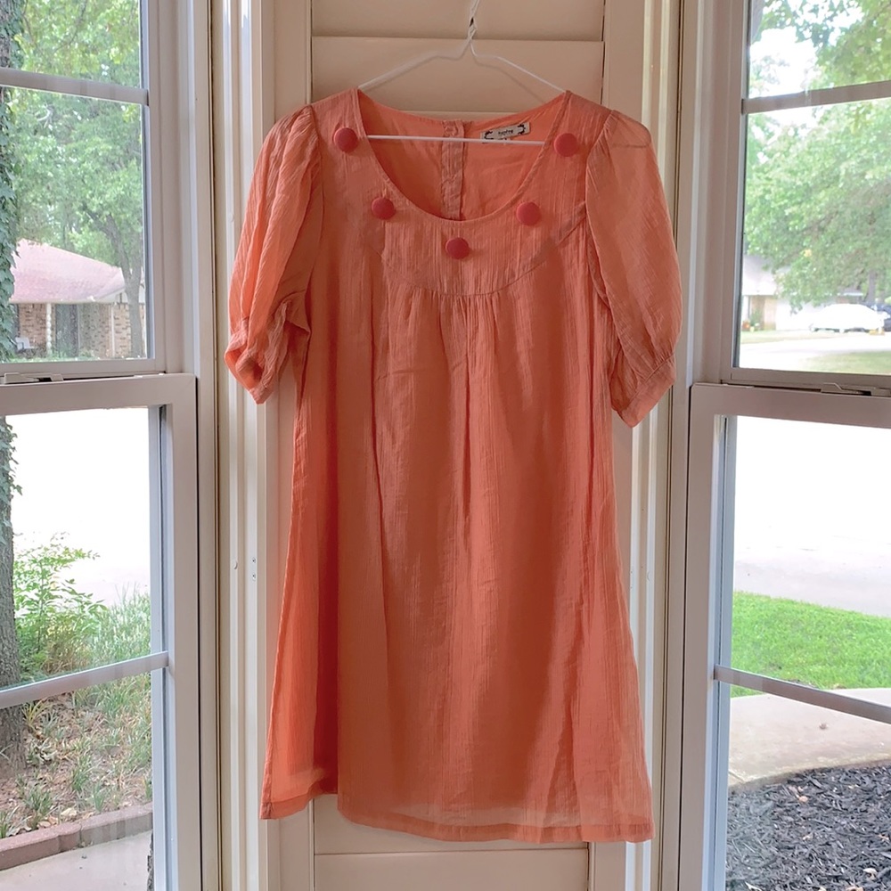 Coral dress with button detailing.